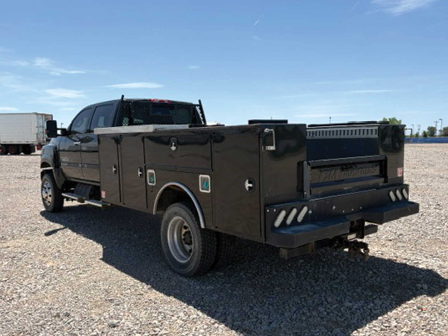 Service/Utility truck showing a 2019 Chevrolet 4500 Silverado HD crew cab 4x4 with a black utility bed and rear retractable steps.