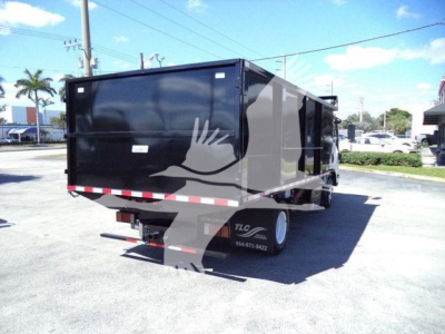 Isuzu NPR HD dump truck trailer showing cargo bed and rear view with TLC logo and phone number on wheel well