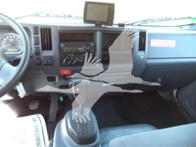 Isuzu NPR-HD truck interior showing dashboard, steering wheel, center controls, gear shifter, and an aftermarket dash-mounted screen.