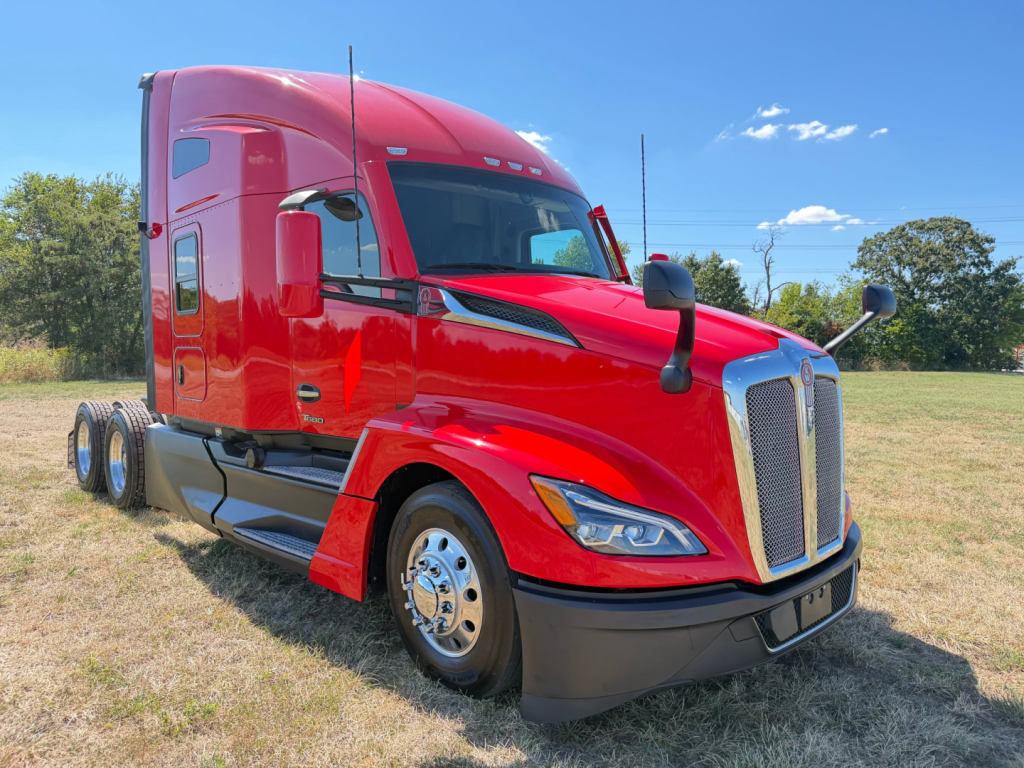 Kenworth T680 conventional sleeper truck in red, side view showing cab, front grille, headlights, and dual rear axles.