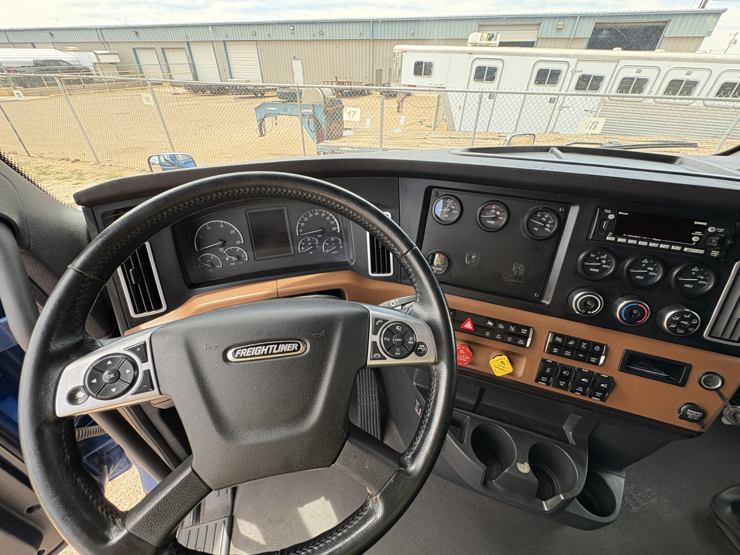 Freightliner Cascadia 126 truck cabin dashboard view with steering wheel and instrument cluster.