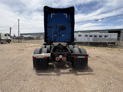Freightliner Casadia 126 chassis rear view showing fifth wheel cradle and dual rear axles with mudflaps and chassis wiring.