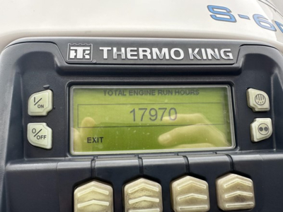 Thermo King controller panel showing total engine run hours 17970 with EXIT on display. Left side has ON/OFF and %/OFF buttons; right side has two round buttons.