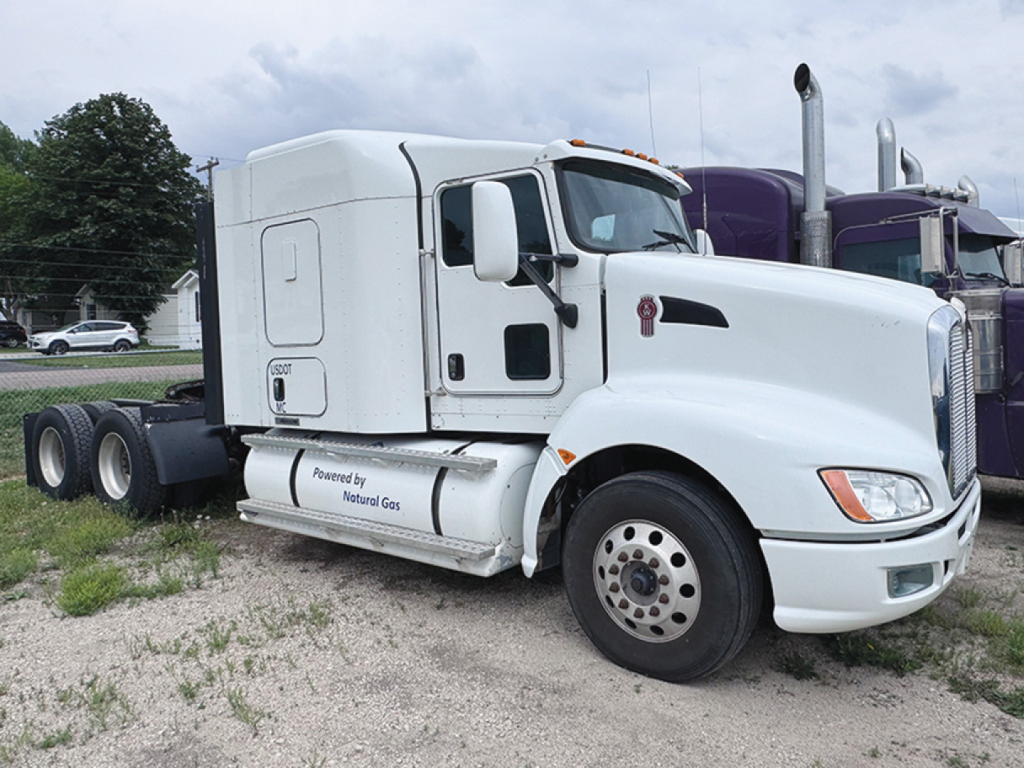White 2014 Kenworth T-660 AeroCab conventional sleeper truck viewed from the front left side showing hood, cab, and fuel tanks.