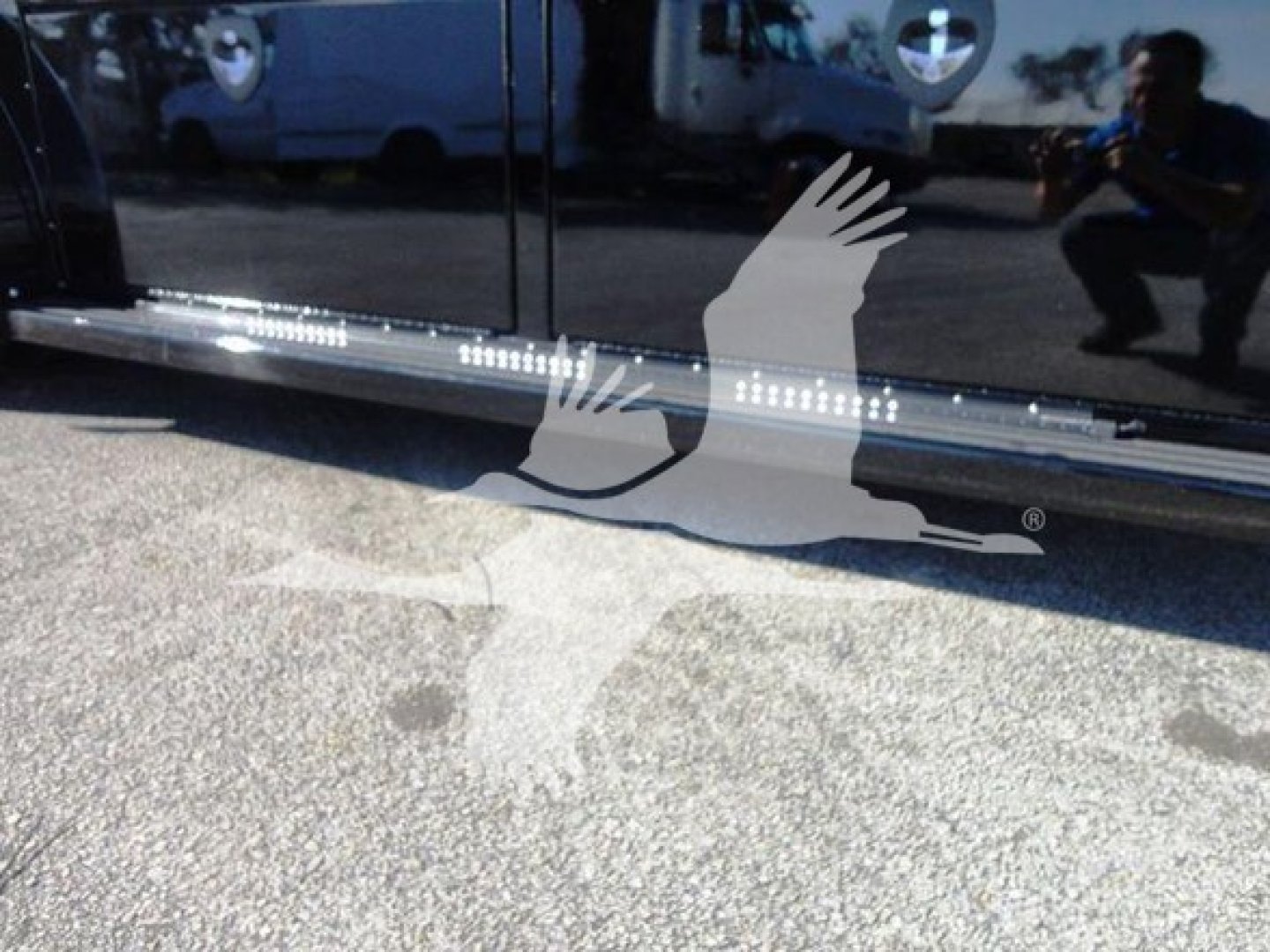Truck side rail with reflective striping and diamond plate step showing ignition-free surface; image includes a watermark overlay.