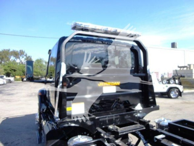Rollback truck cab rear view showing Jerr-Dan logo and equipment mount.