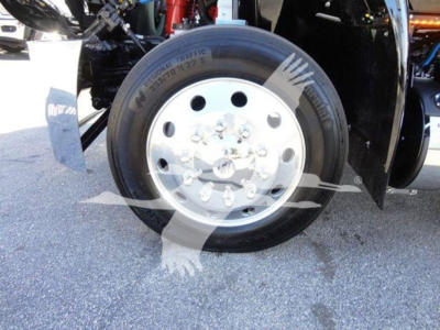 Truck wheel and tire close-up showing steel rim and Michelin tire labels visible on the front axle.