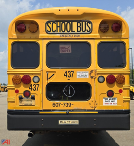 Rear view of a 2017 Blue Bird Vision school bus with yellow body, bus numbers 437, and rear lights visible.