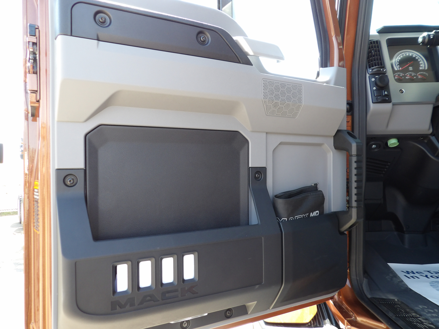Mack MD7 truck door interior panel and dashboard view showing door pocket and control area.