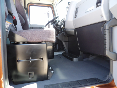 Cab interior of a new 2026 Mack MD7 dump truck showing dashboard, steering wheel, and seating area.