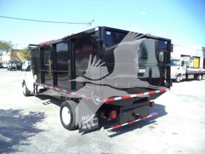 Dump truck body side view showing black Tilting dump bed with reflective safety tape and rear hydraulic mechanisms.