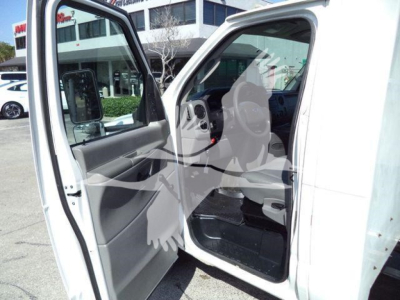 Ford E-450 cargo van interior view with front passenger door open showing dash and seat area.