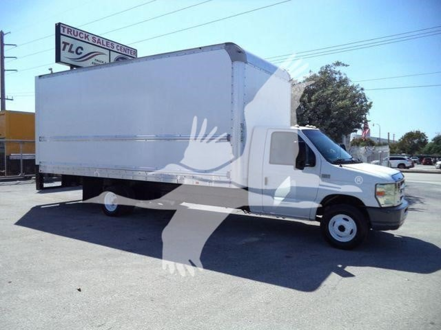 Box truck on dealership lot showing 2011 Ford E450 with a large white box cargo area.