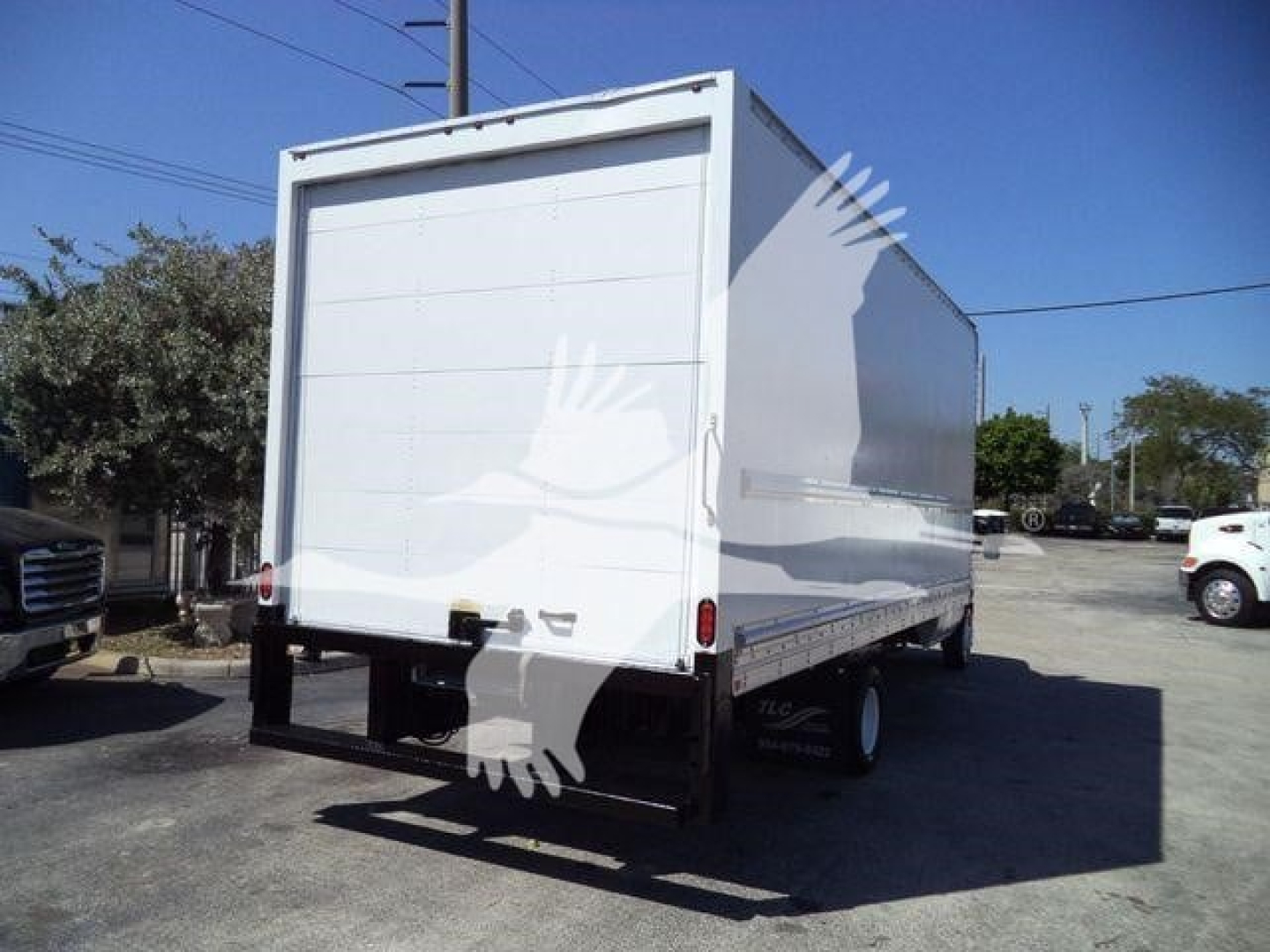 Box truck rear view showing cargo box and bumper with taillights on a Ford E-450 chassis.