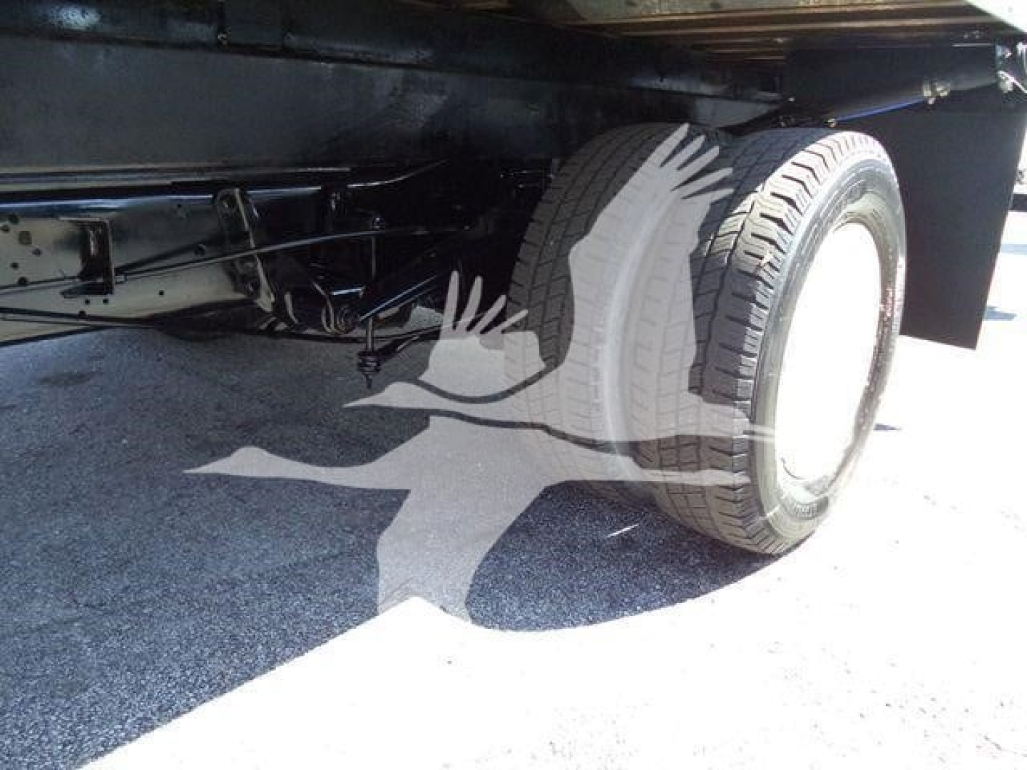 Ford E-450 box truck undercarriage showing rear dual wheels and chassis components.