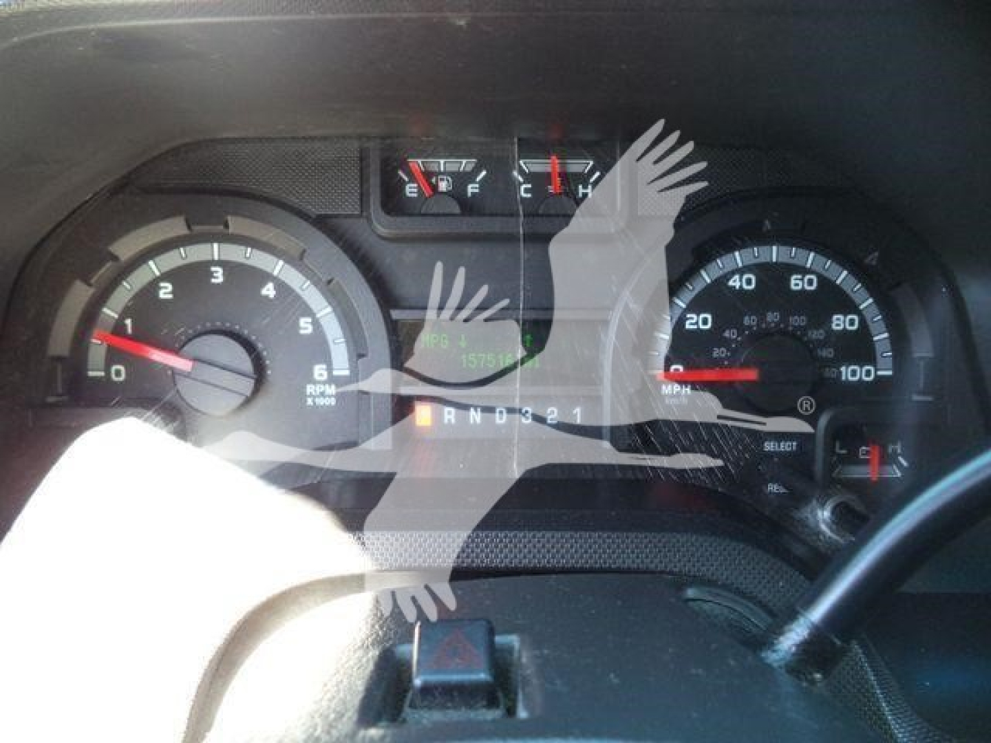 Ford E-450 instrument cluster showing tachometer, speedometer, and gear selector with indicator lights and odometer reading.