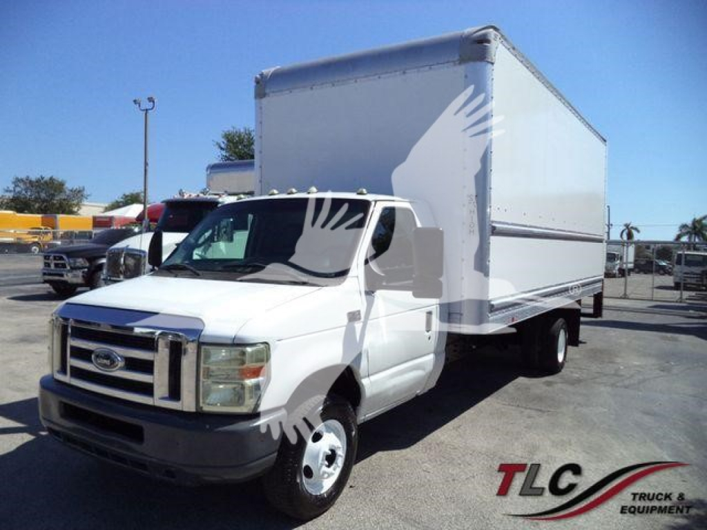 Ford E450 box truck with large cargo box and cab in front, front grille and wheel visible, used vehicle for sale.