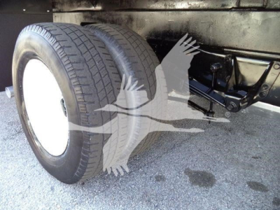 Ford E-450 box truck rear dual wheels and suspension visible undercarriage with tires and chassis components.