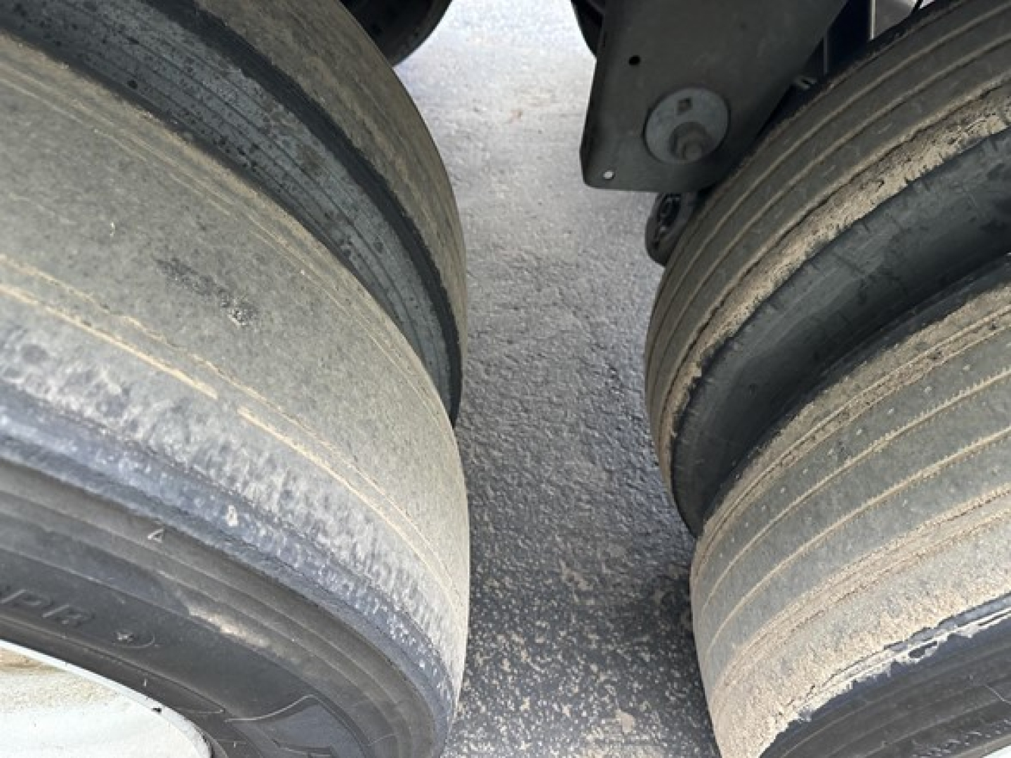 Trailer wheel tires on a Wabash Duraplate 53' air ride dry van trailer showing dual axles with wear marks and road grime.