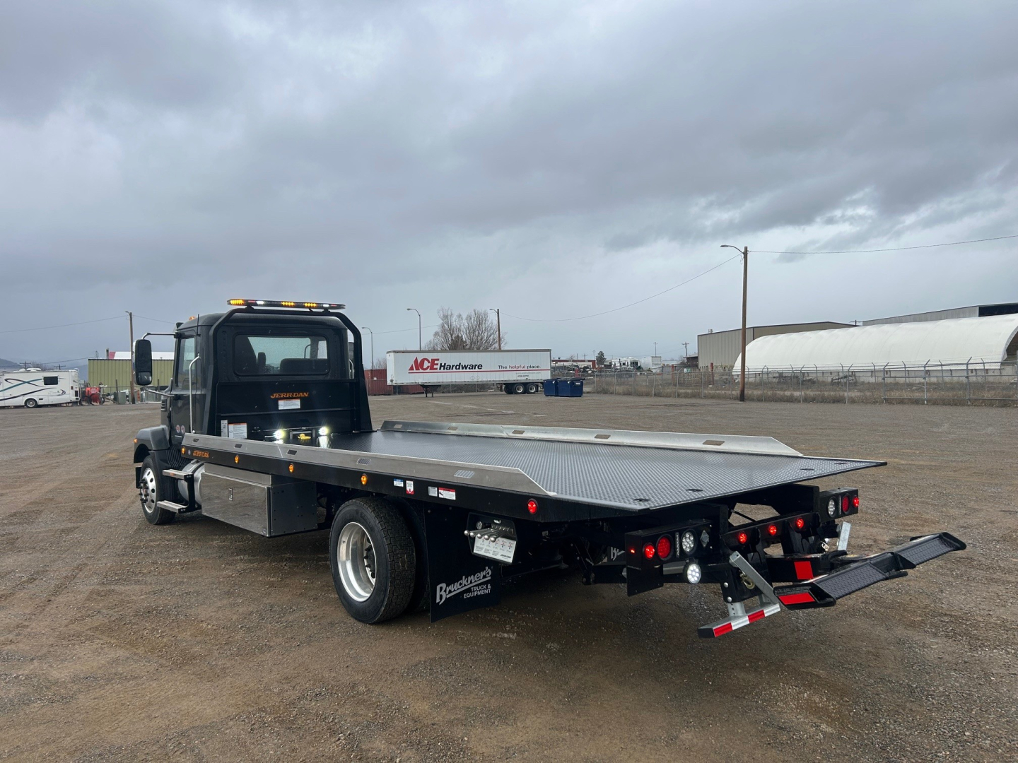 Mack MD6 rollback truck with flatbed and hydraulic rear ramps