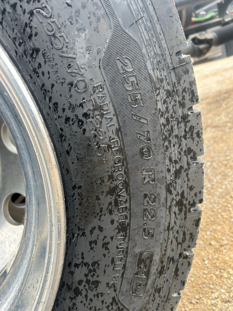 Tire sidewall with 255/70R22.5 and Load Range D on a Mack MD6 rollback truck. Visible markings include 255/70R22.5, 10PR, and tubed lettering along the tread.