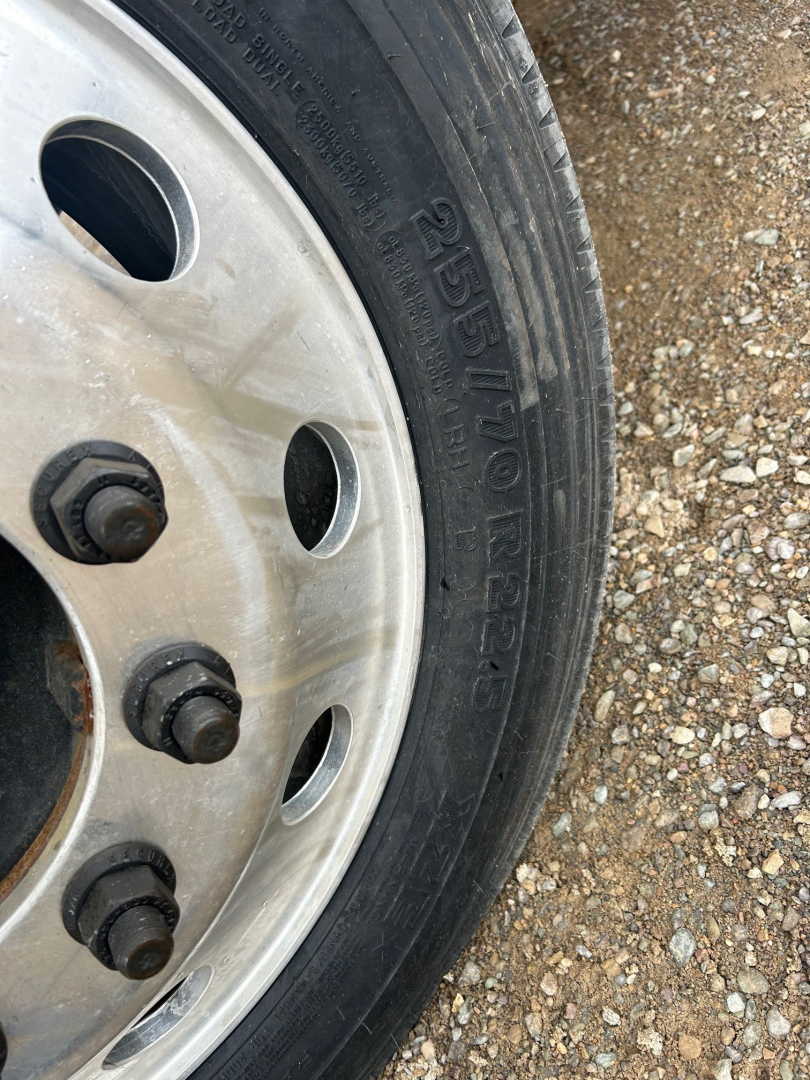 Wheel and tire of 2026 Mack MD6 truck showing 265/70 R22.5 tire sidewall and steel wheel.