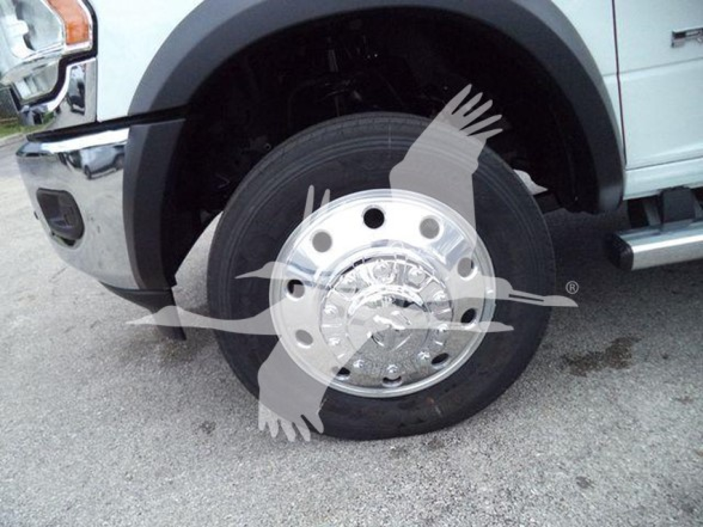 Ram 4500 front wheel and fender showing wheel hub and tire with chrome hubcap.