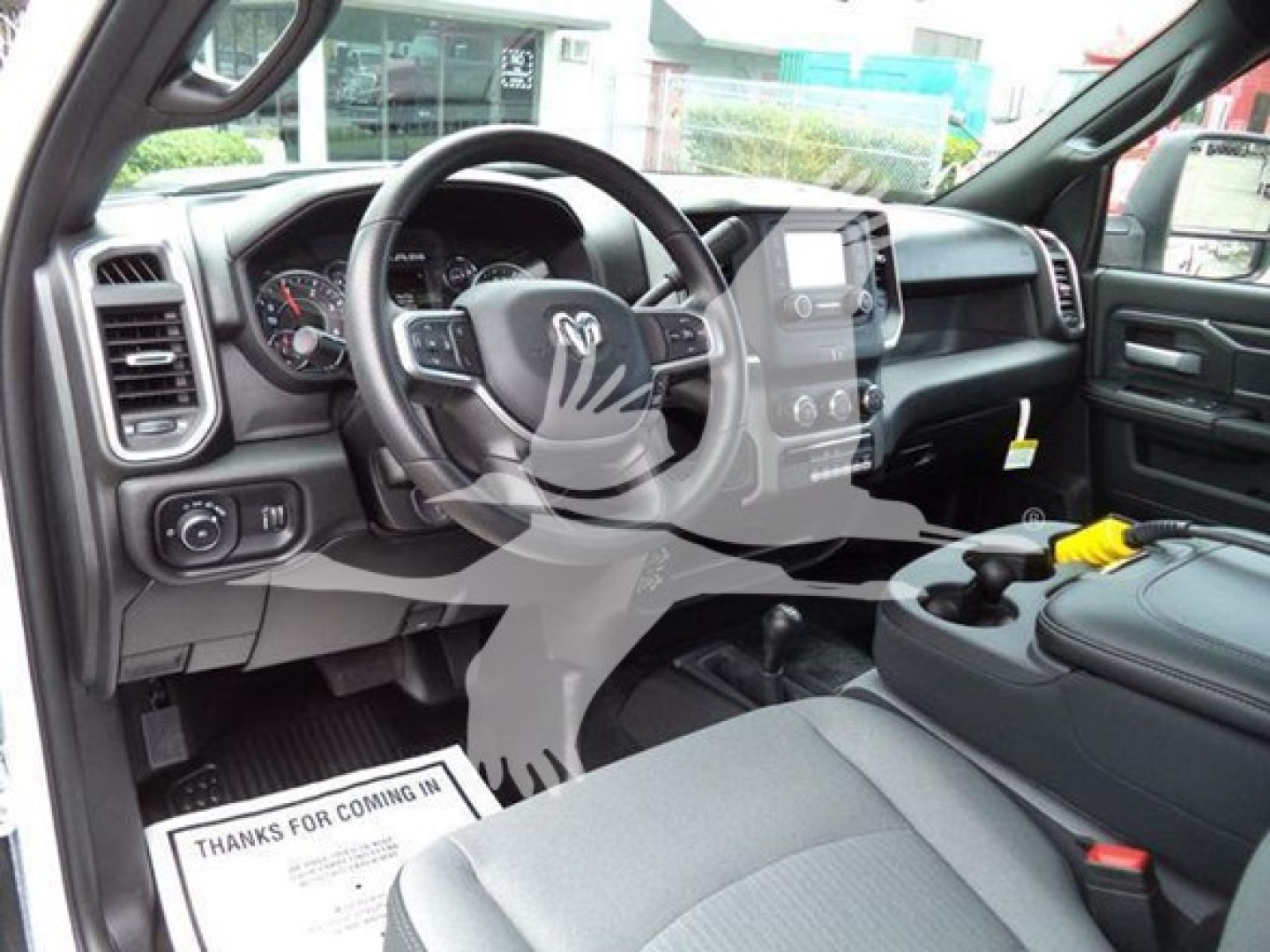 Interior of a 2024 Ram 4500 SLT pickup truck showing dashboard, steering wheel with Ram logo, center console, and front seats.