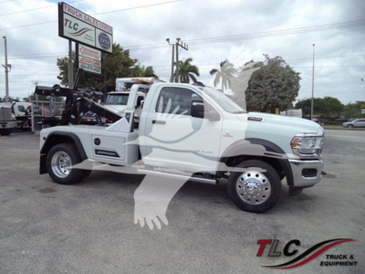Ram 4500 Tow Truck side view showing white cab and rear flatbed with winch, SMA branding, and chrome dual rear wheels.