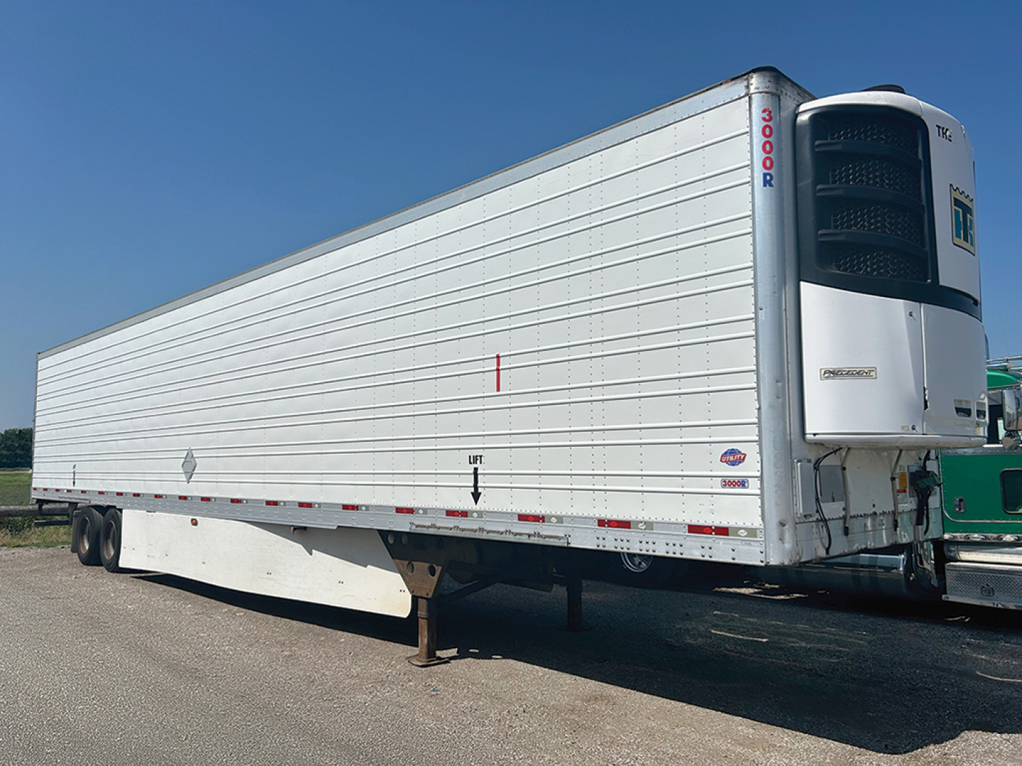 Trailer side of a 2016 Utility 3000R refrigerated trailer showing rear refrigeration unit and '3000R' vertical text on the front corner; no other legible text visible.