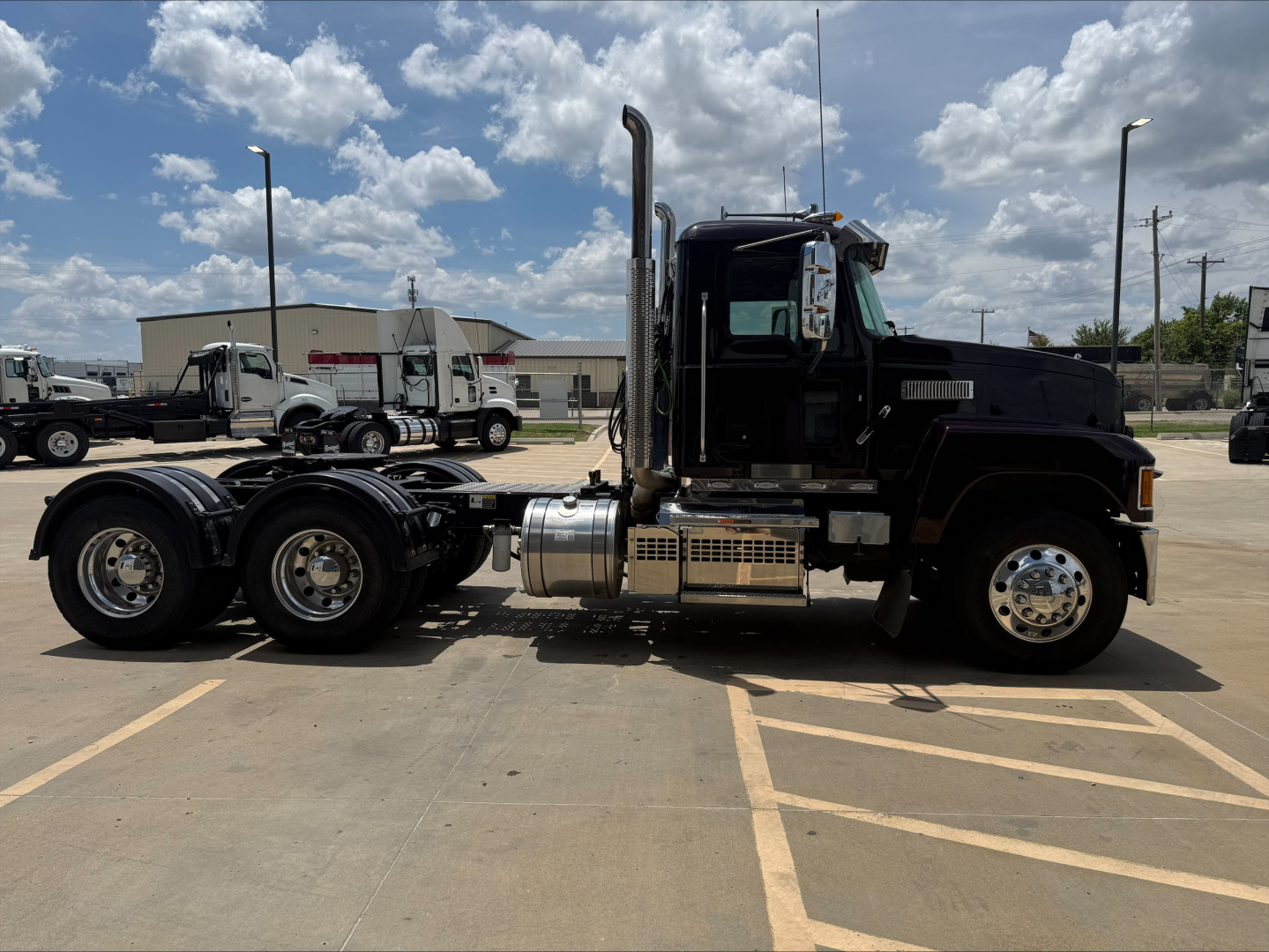 Mack PI64T truck side view showing cab, exhaust stacks, fuel tanks, and dual rear axles