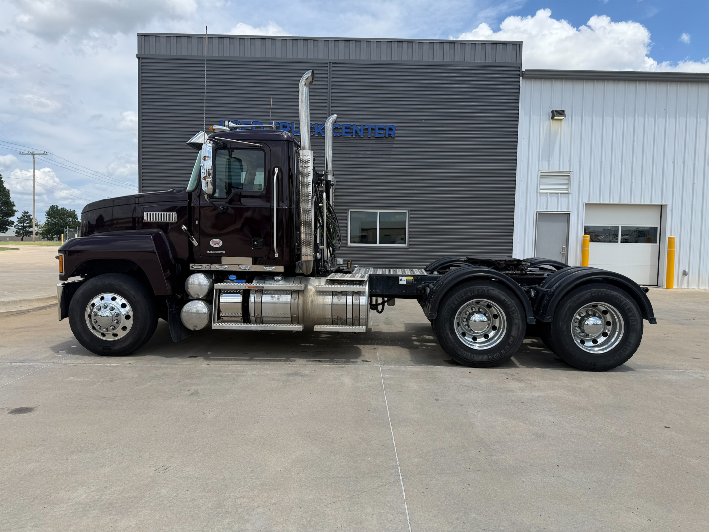 Mack PI64T conventional daycab truck side view showing chassis and dual rear axles.