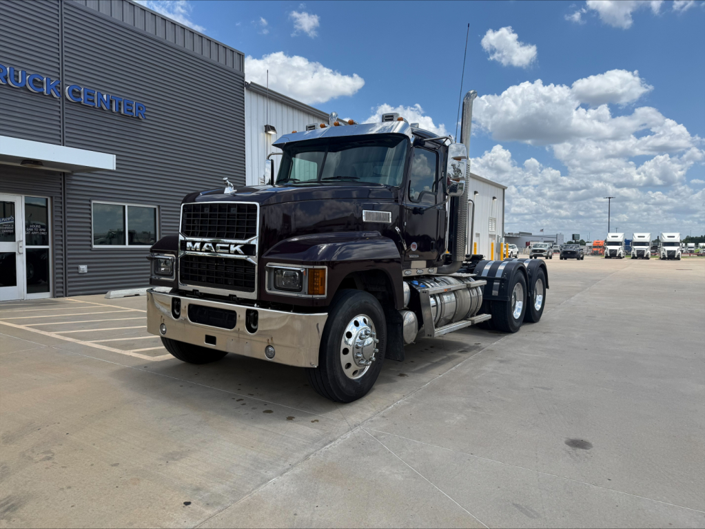 Mack PI64T conventional daycab truck shown from front-left view with chrome grille and dual rear axles.