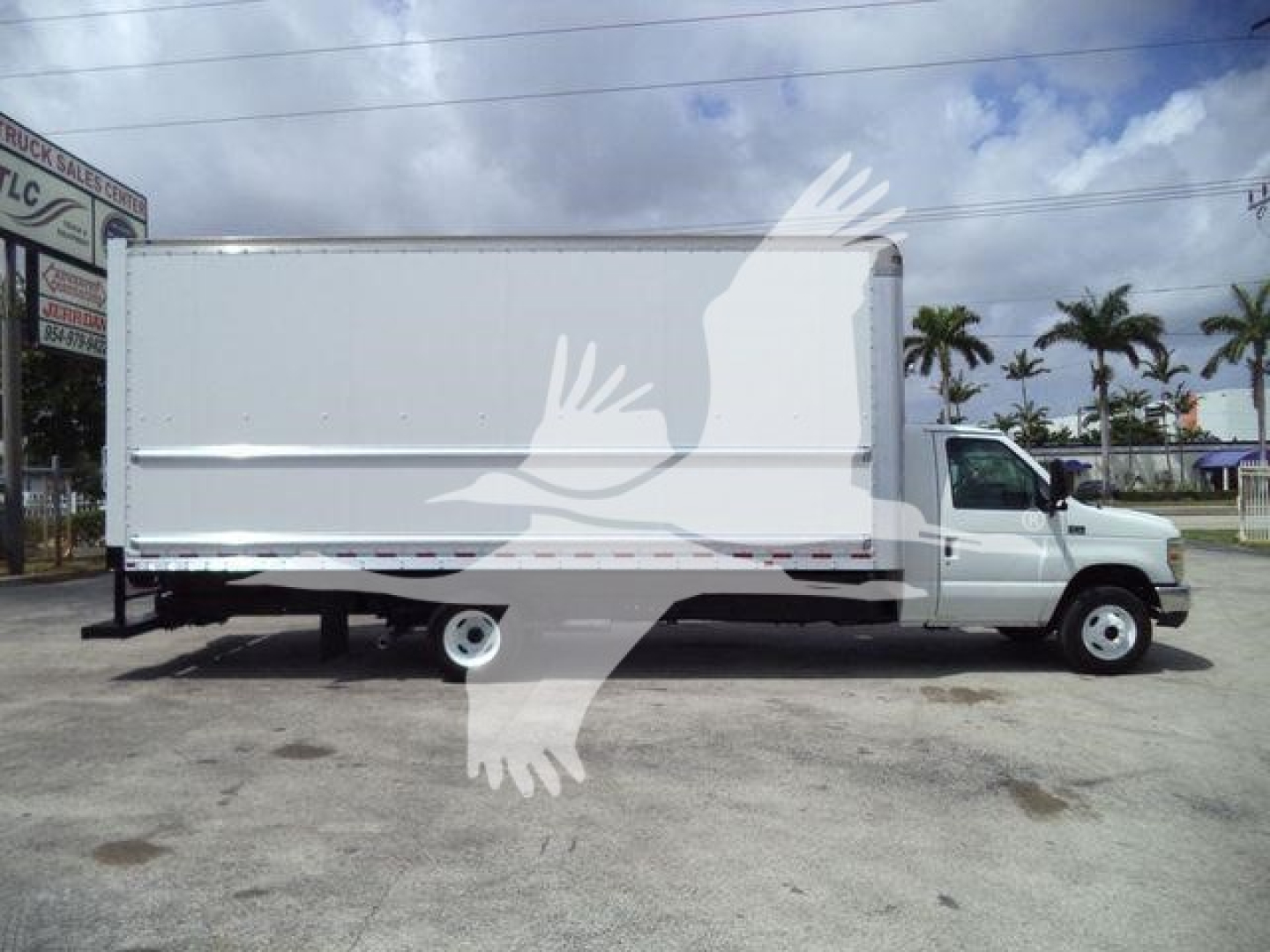 2011 Ford E450 box truck side view showing cargo box, cab with front wheel and rear wheel visible.