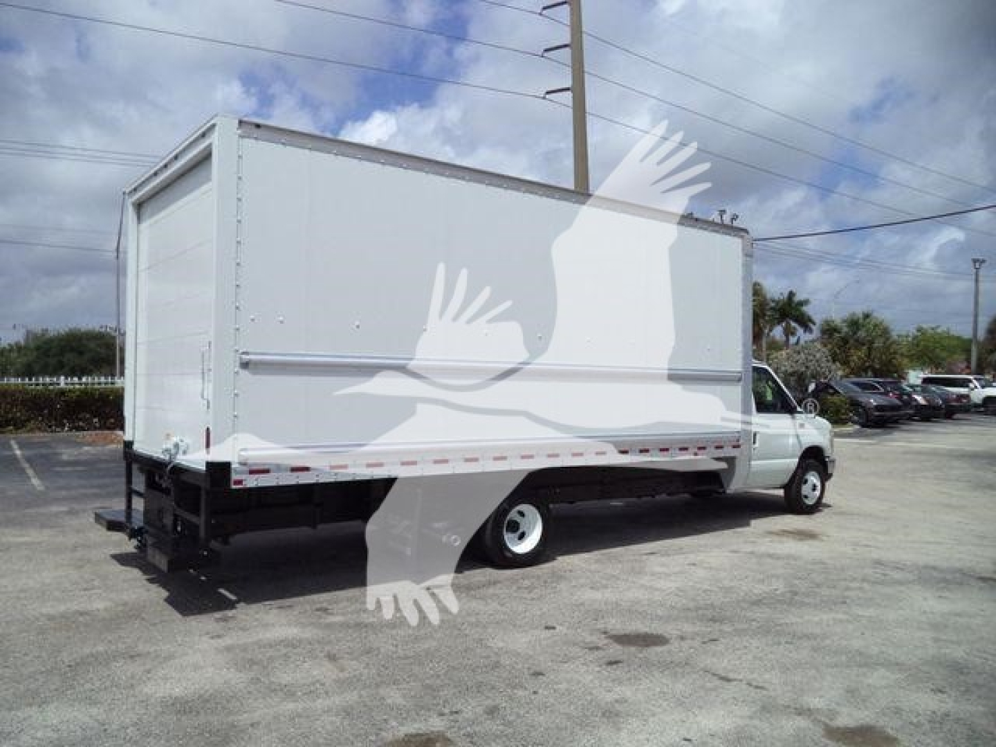 Box truck rear and side view showing cargo box and cab on a 2011 Ford E450 with white cargo body.