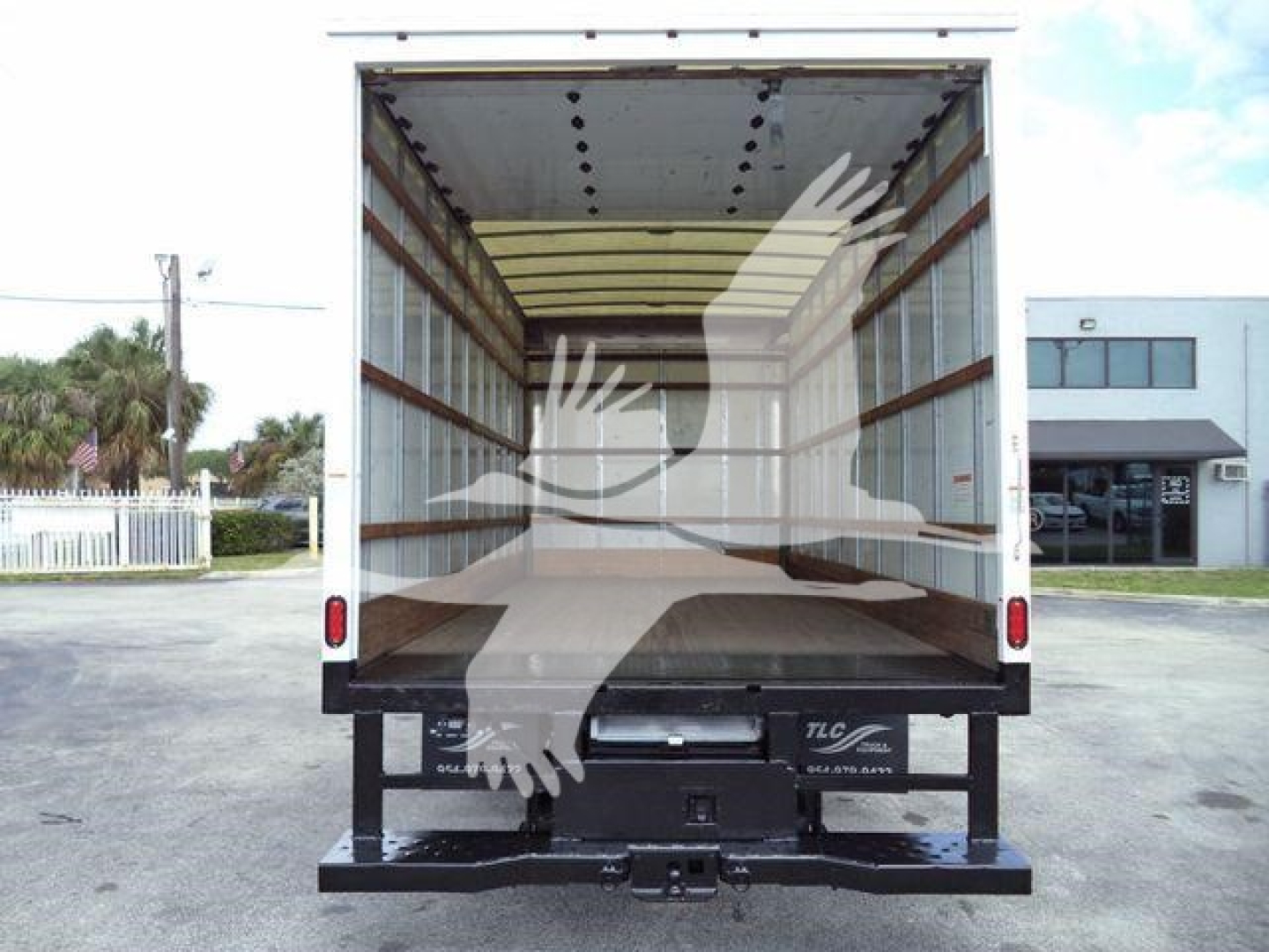 Rear view of 2011 Ford E450 box truck cargo area with open rear doors, empty interior, stock number T02379FM.