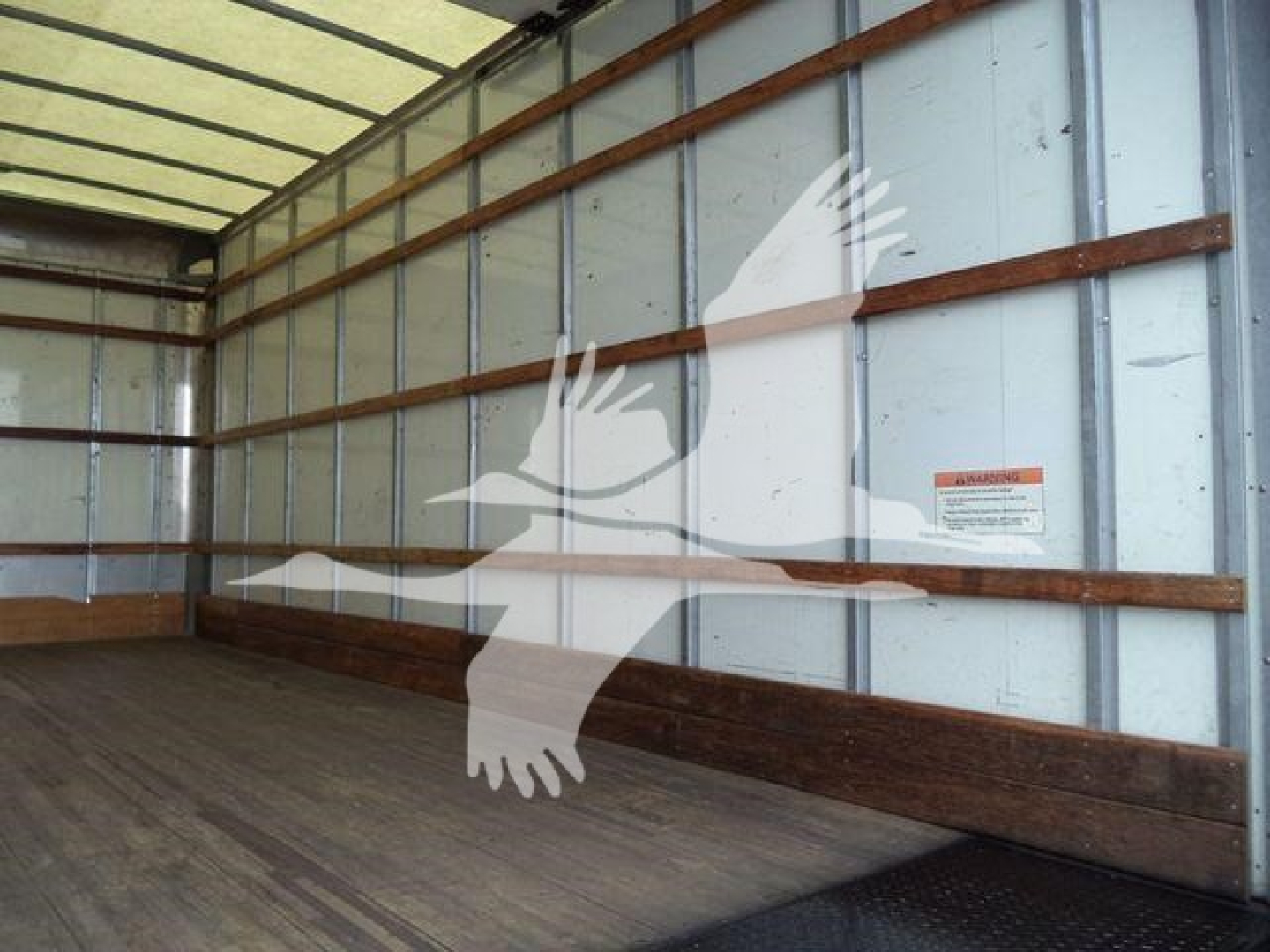 Ford E450 box truck cargo area with wooden side rails and metal walls.