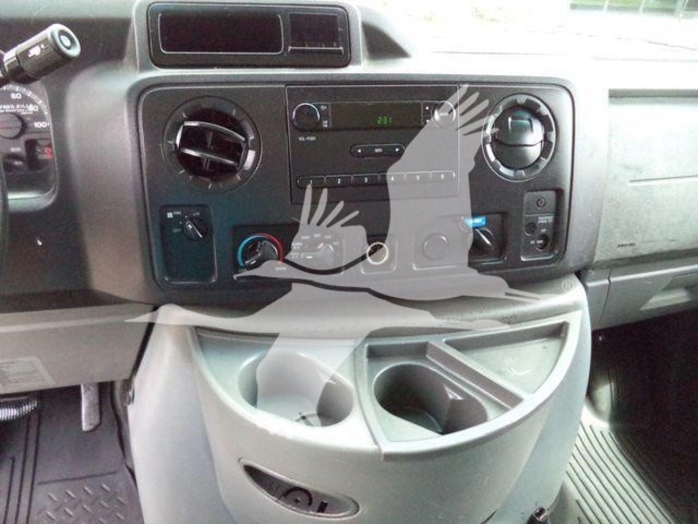 Ford E-450 dashboard and center console with HVAC controls and cup holders.