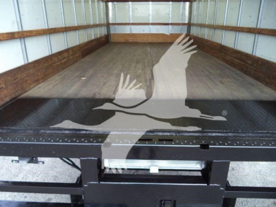 Truck bed of a 2011 Ford E450 box truck showing empty cargo area and ramp gate.
