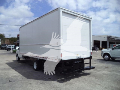 Box truck rear-view showing enclosed cargo area on Ford E450 with liftgate and dual rear wheels.