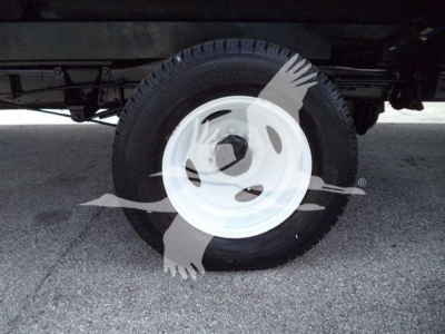 Ford E-450 wheel and tire underbox truck shows white steel rim and black tire.
