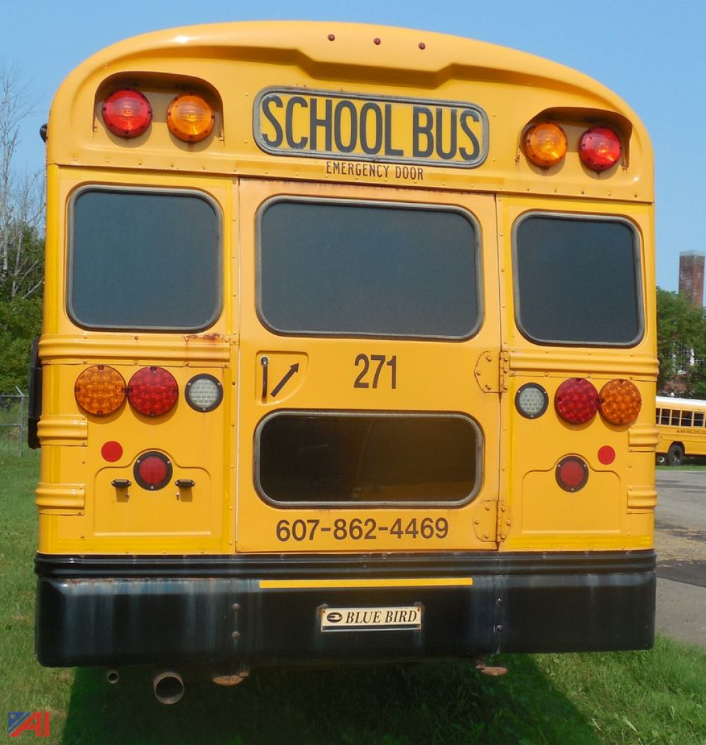 Yellow Blue Bird school bus rear view with emergency door, bus number 271, and contact number 607-862-4469.