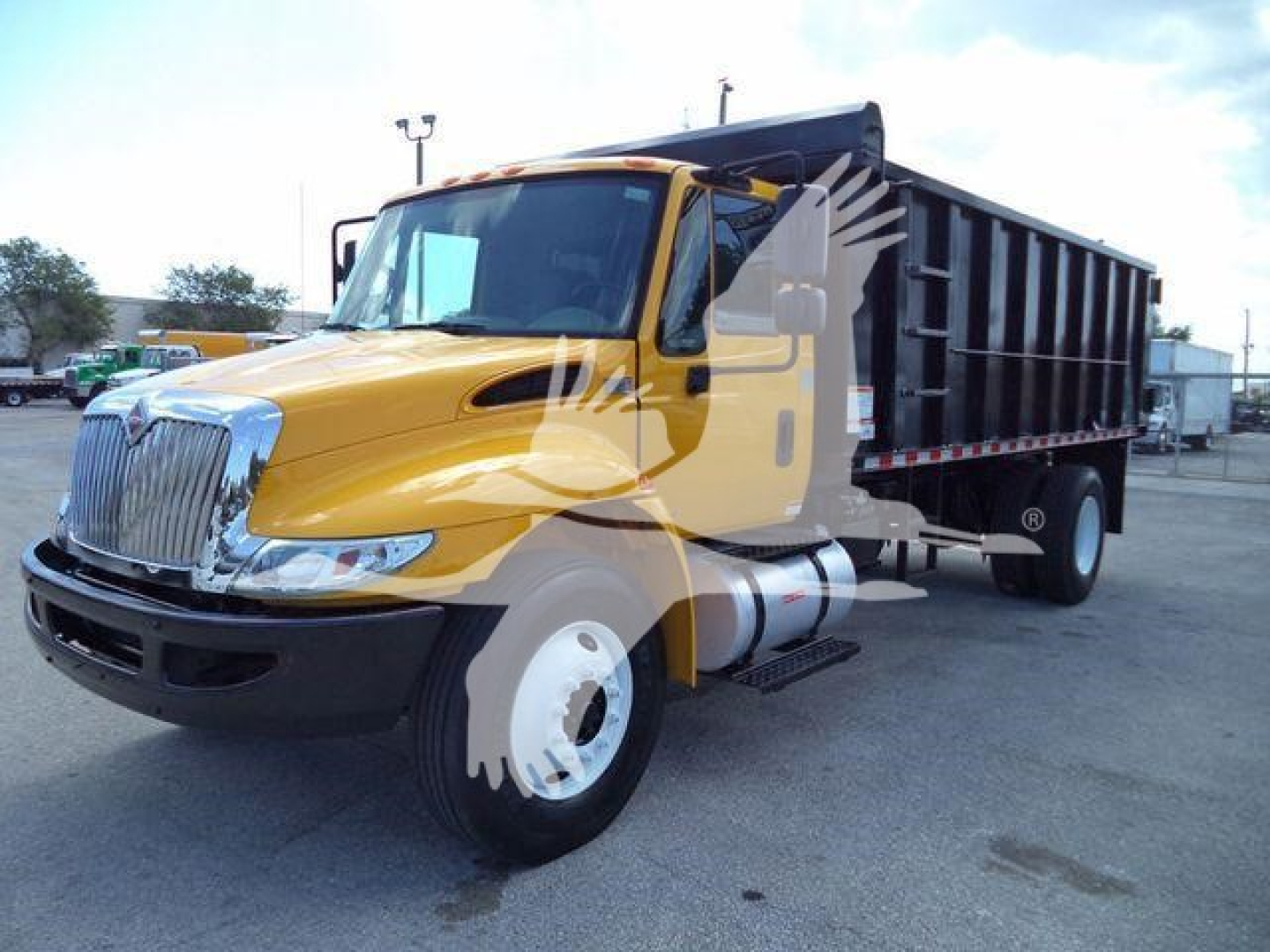 2019 International 4300 dump truck in yellow and black with a black dump bed, front grille and headlights visible.