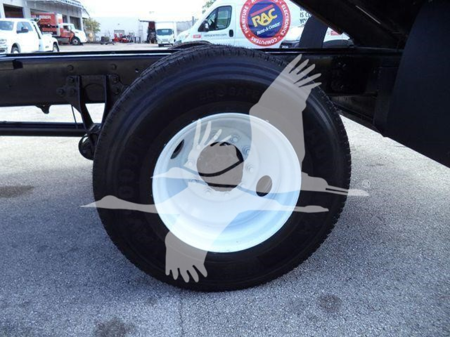 Wheel and tire on the chassis of a 2019 International 4300 truck showing a white steel rim.
