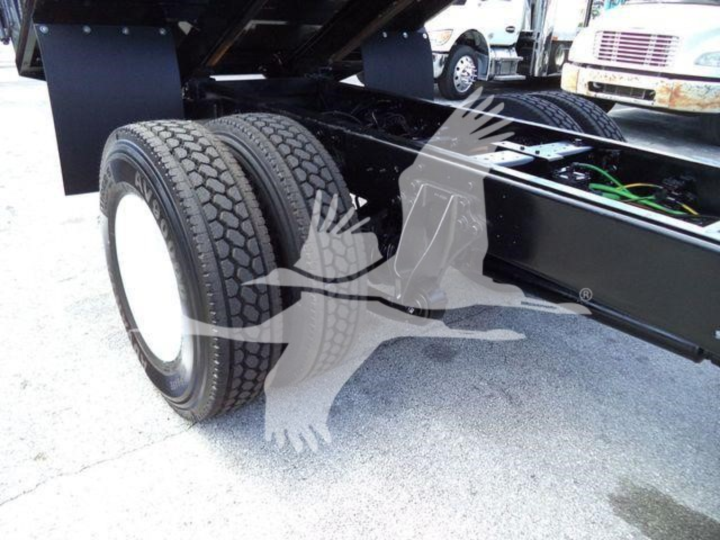 Dual rear wheels and chassis of a 2019 International 4300 truck showing suspension and frame.