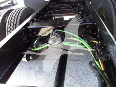 Truck chassis underside with green braided lines and black metal frame viewed from beneath a 2019 International 4300 chassis.
