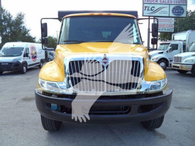 Front view of a yellow 2019 International 4300 truck with large chrome grille and black bumper.