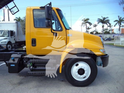 Orange 2019 International 4300 truck side view with cab door, fuel tank, and wheel visible.