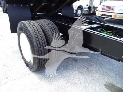 Dual rear wheels and chassis of a 2019 International 4300 truck showing suspension and frame.