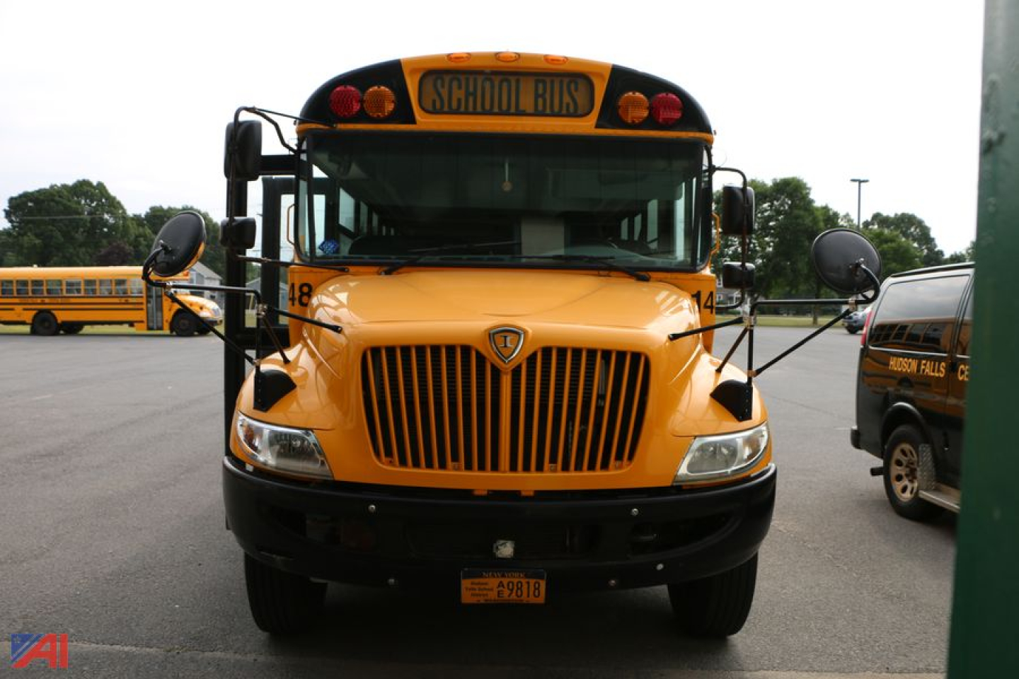 Front view of a yellow 2015 IC Corporation CE Series school bus showing grille, headlights, warning lights, and School Bus sign on top